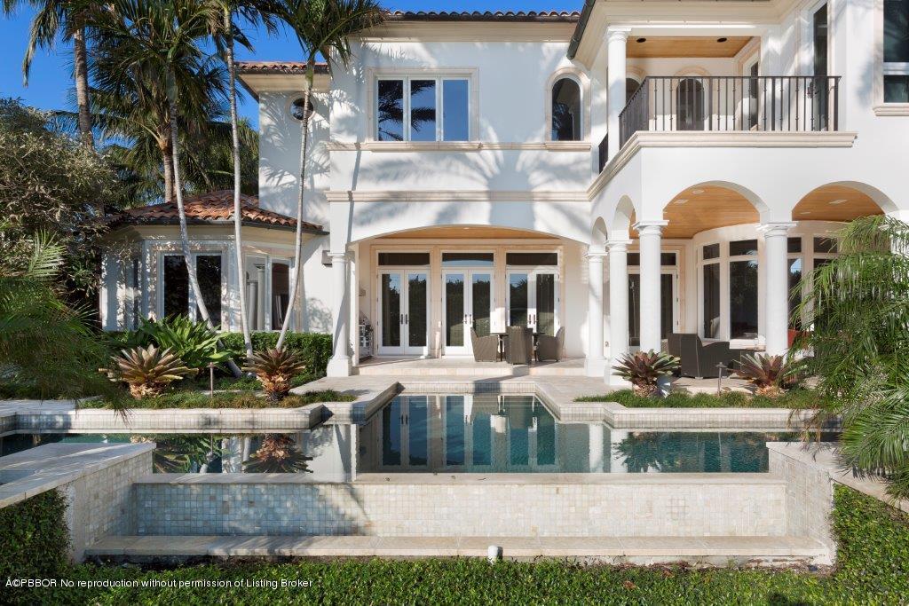 95 Curlew Road Manalapan, FL 33462 - Photo 26 of 36 a view of a white building with couches and a fireplace