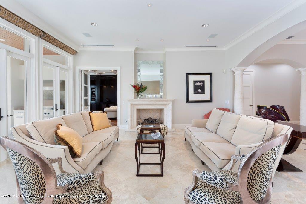95 Curlew Road Manalapan, FL 33462 - Photo 5 of 36 a living room with furniture a fireplace and a table