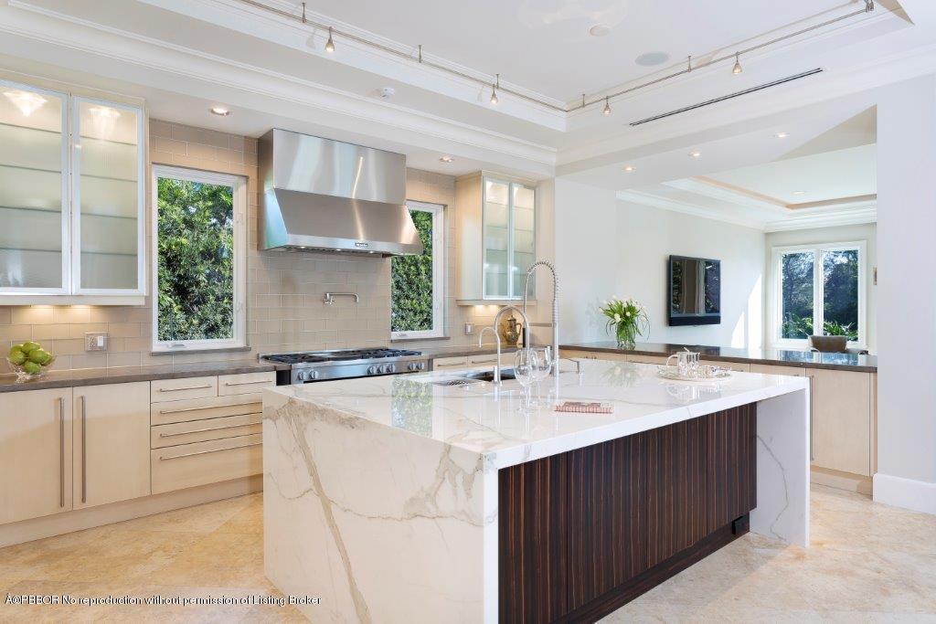 95 Curlew Road Manalapan, FL 33462 - Photo 7 of 36 a kitchen with a sink stove and cabinets