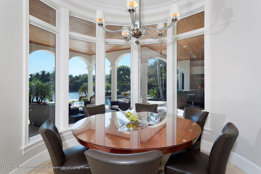 95 Curlew Road Manalapan, FL 33462 - Photo 8 of 36 a dining room with furniture a chandelier and wooden floor