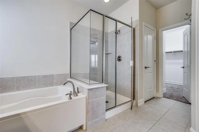 a bathroom with a bathtub and a shower