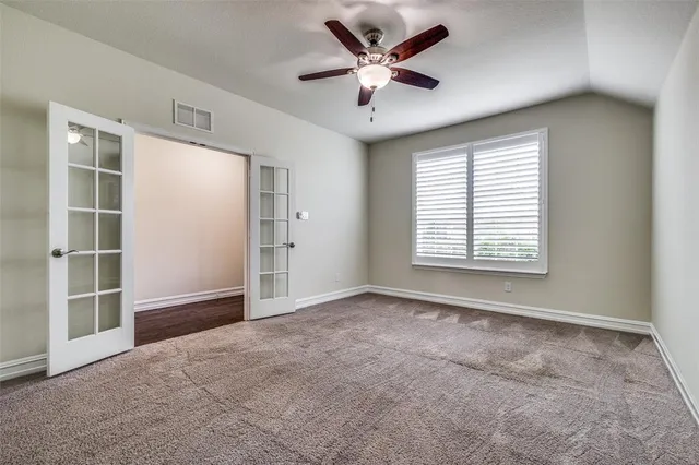 an empty room with windows and closet