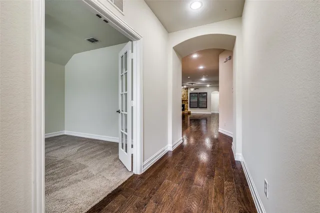 a view of a hallway view with wooden floor and staircase