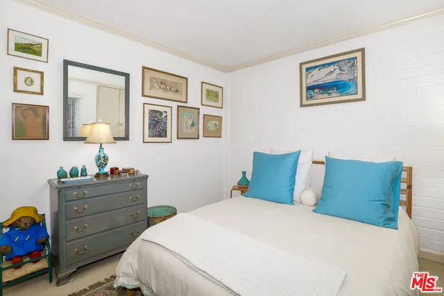 a bedroom with a bed and a baby crib