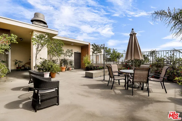 a view of a patio with a table and chairs