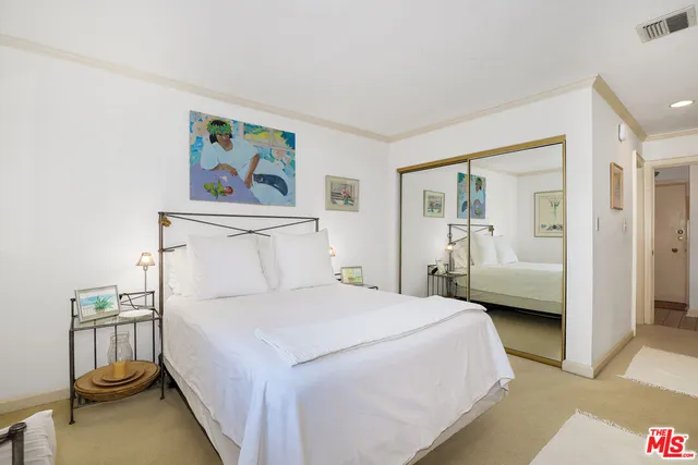 a bedroom with a bed and a view of bathroom