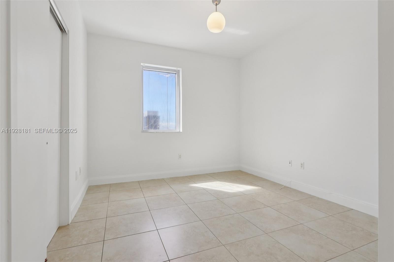1060 Brickell Avenue, Unit 2607 Miami, FL 33131 - Photo 23 of 46 an empty room with a white door