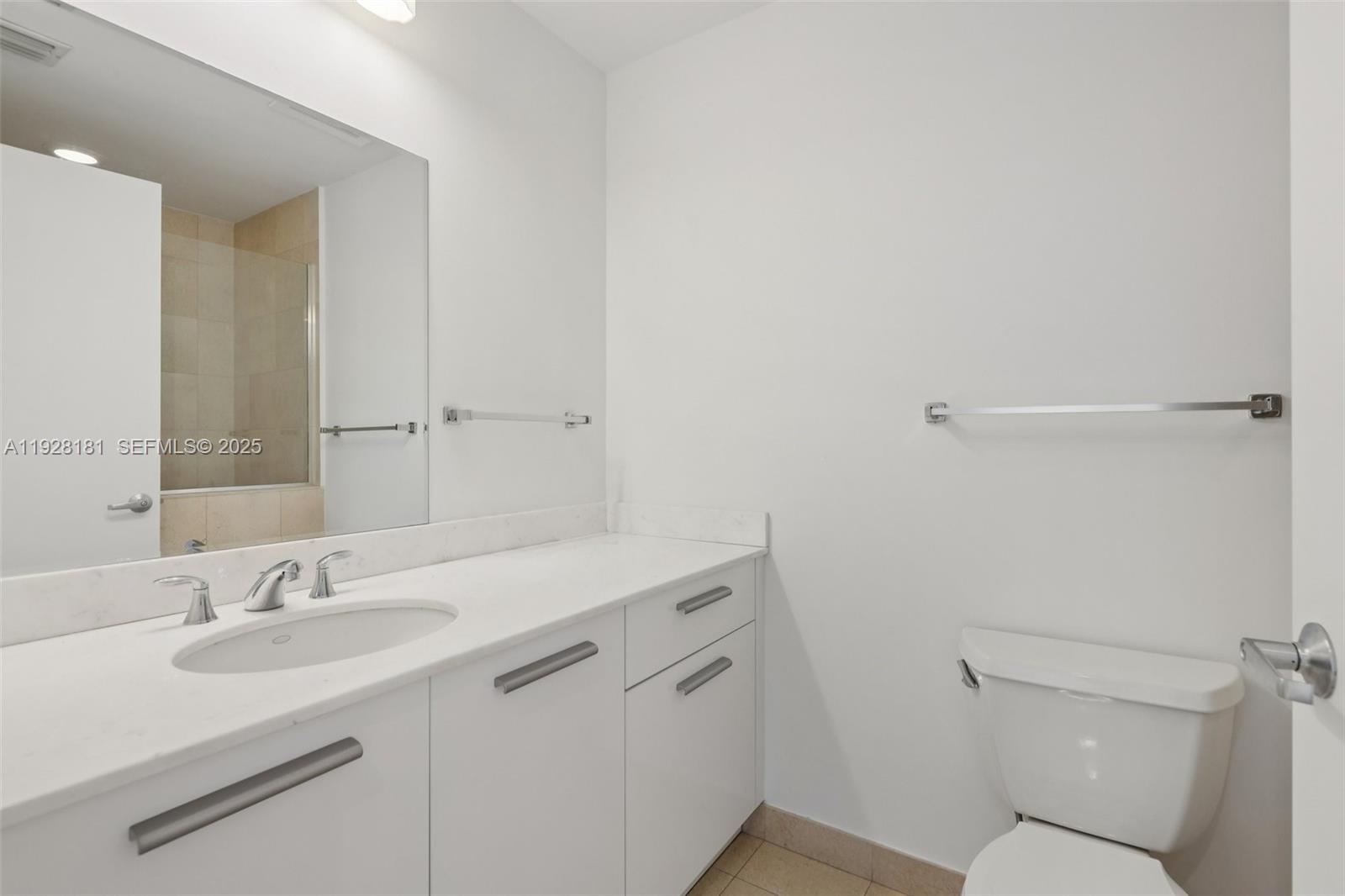 1060 Brickell Avenue, Unit 2607 Miami, FL 33131 - Photo 28 of 46 a bathroom with a sink toilet and a mirror