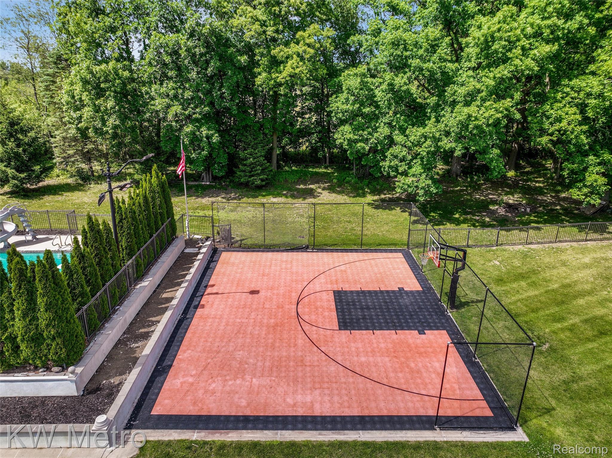 65884 Windrose Court Ray, MI 48096 - Photo 24 of 82 Sport court with red and black modular tile surfacing