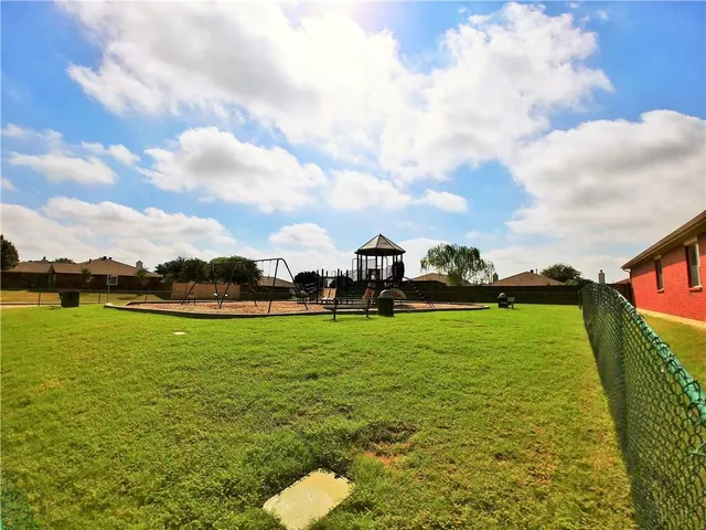 a view of a swimming pool with an outdoor seating and a yard
