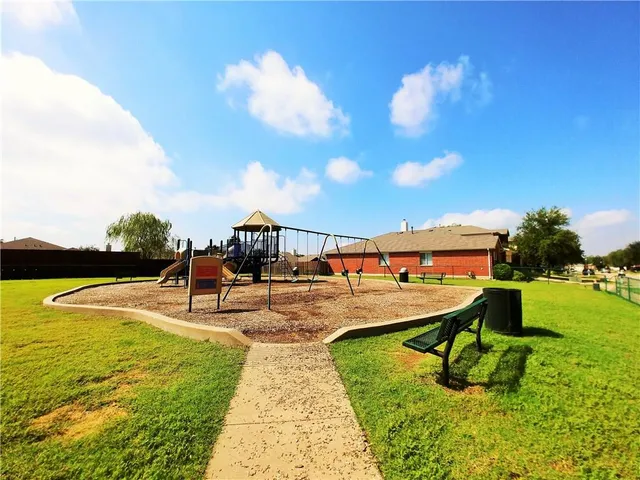 a view of a park with swings and slides