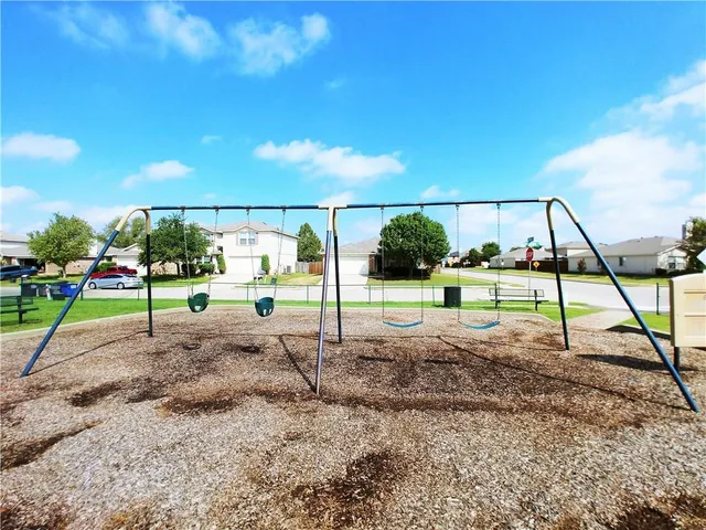 a view of a swimming pool with a table and chairs under an umbrella
