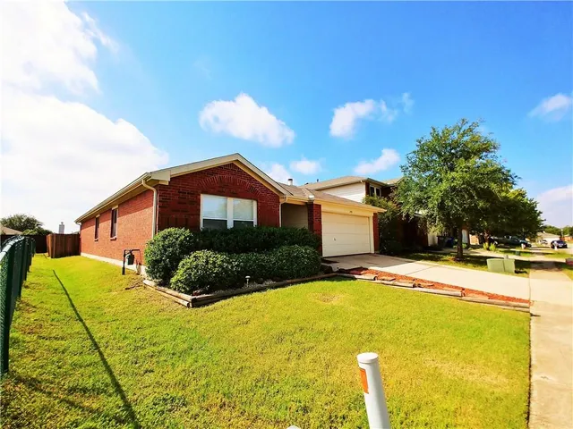 a front view of house with yard and trees