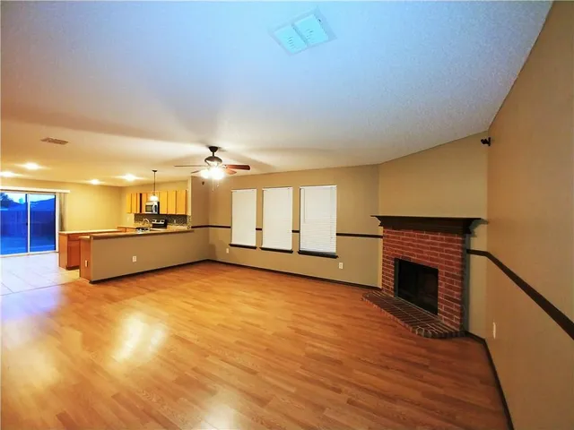 a view of a kitchen with a sink and a fireplace