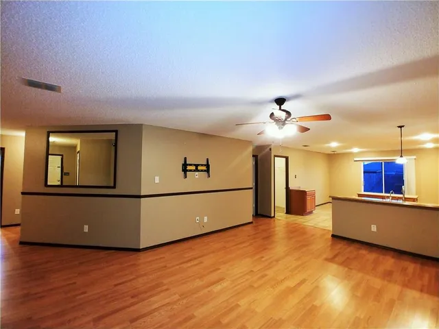 a view of kitchen with furniture and a ceiling fan