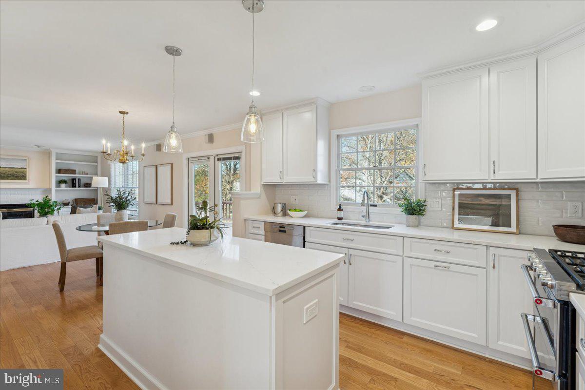 12546 Rock Ridge Road Herndon, VA 20170 - Photo 2 of 44 a kitchen with stainless steel appliances kitchen island a table chairs sink and cabinets