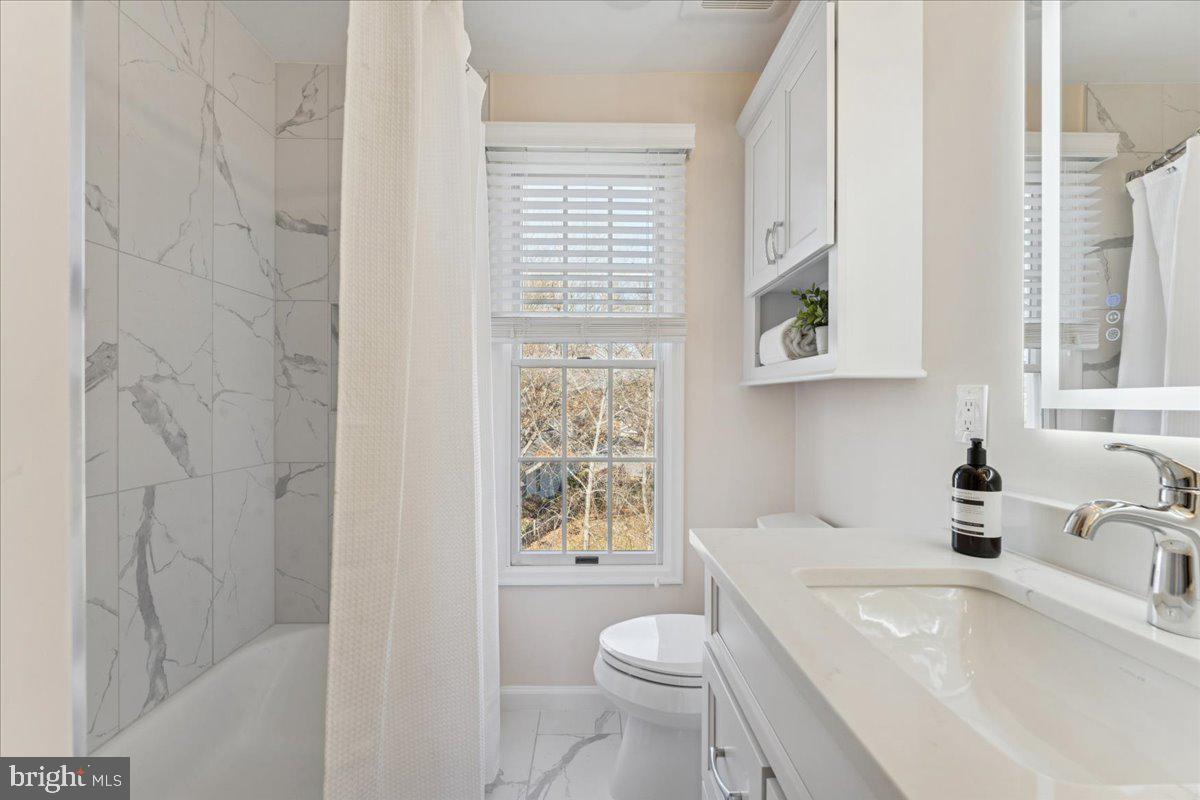 12546 Rock Ridge Road Herndon, VA 20170 - Photo 22 of 44 a bathroom with a sink a toilet and shower