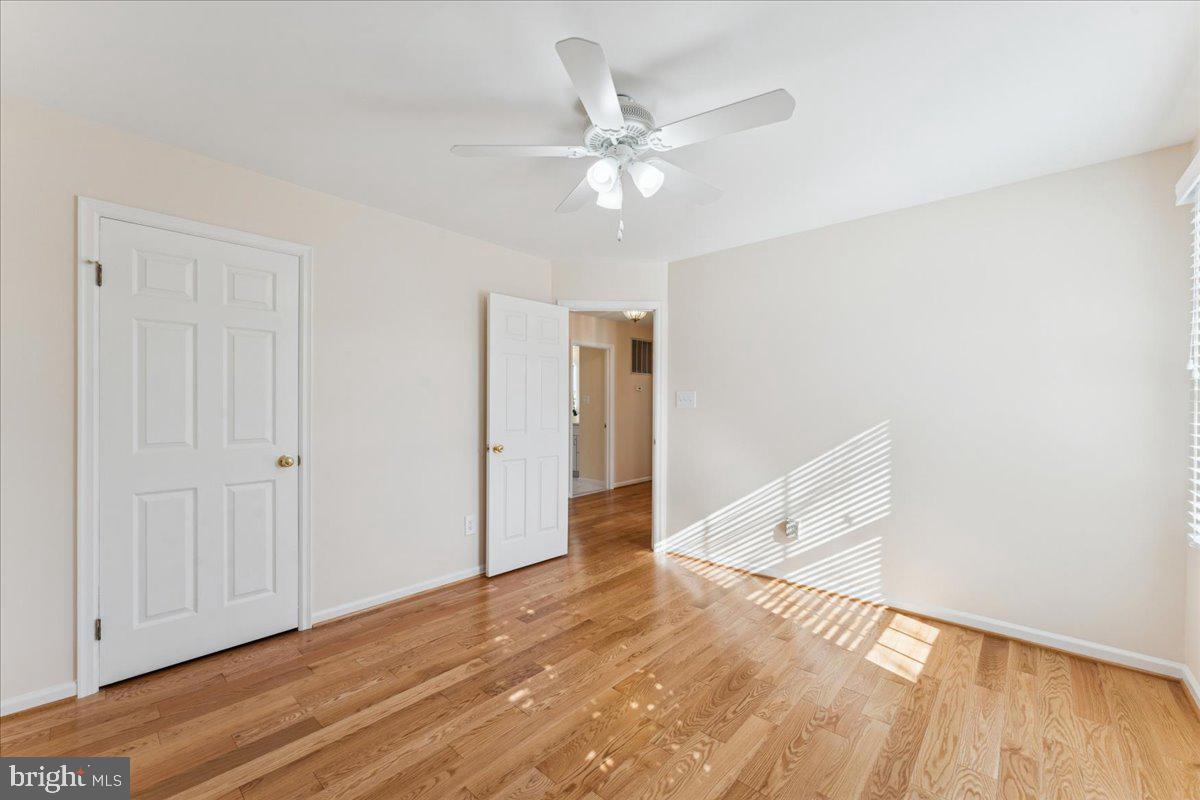 12546 Rock Ridge Road Herndon, VA 20170 - Photo 25 of 44 a view of a room with wooden floor and white walls
