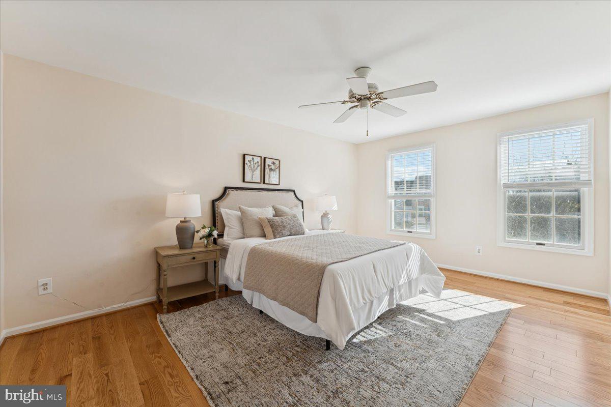 12546 Rock Ridge Road Herndon, VA 20170 - Photo 27 of 44 a bedroom with a bed and wooden floor