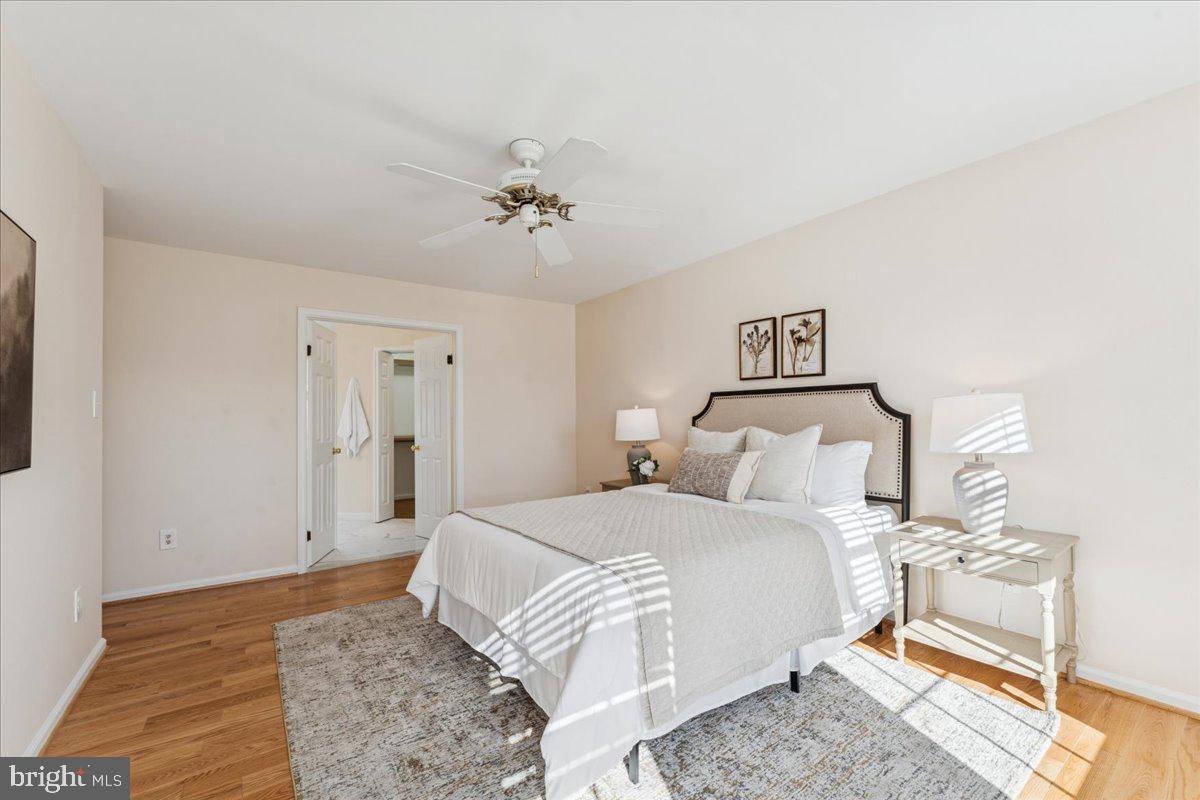 12546 Rock Ridge Road Herndon, VA 20170 - Photo 29 of 44 a bedroom with a bed and a chandelier