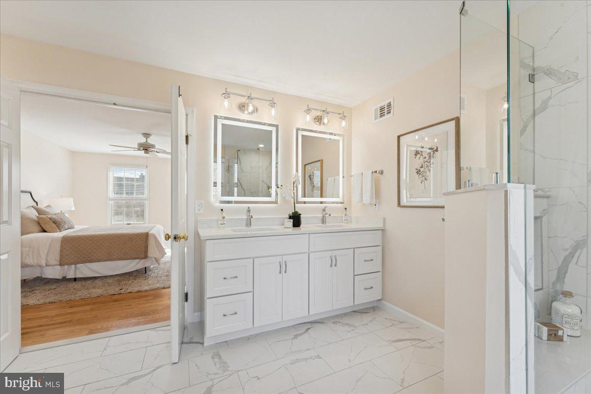 12546 Rock Ridge Road Herndon, VA 20170 - Photo 30 of 44 a spacious bathroom with a granite countertop sink mirror and bathtub