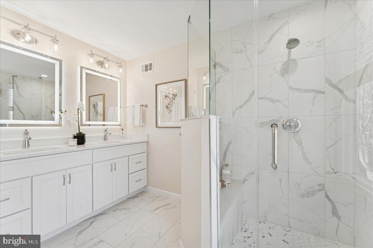 12546 Rock Ridge Road Herndon, VA 20170 - Photo 31 of 44 a spacious bathroom with double sink shower and two mirror