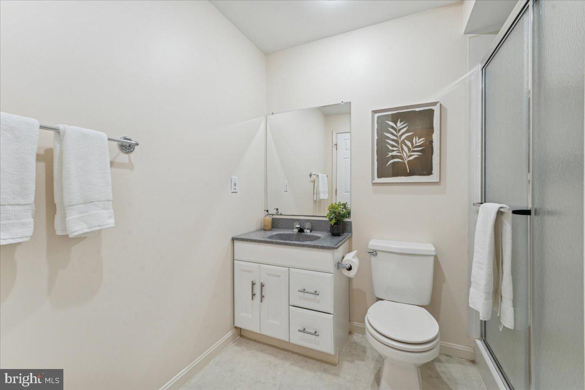12546 Rock Ridge Road Herndon, VA 20170 - Photo 37 of 44 a bathroom with a granite countertop toilet sink and mirror