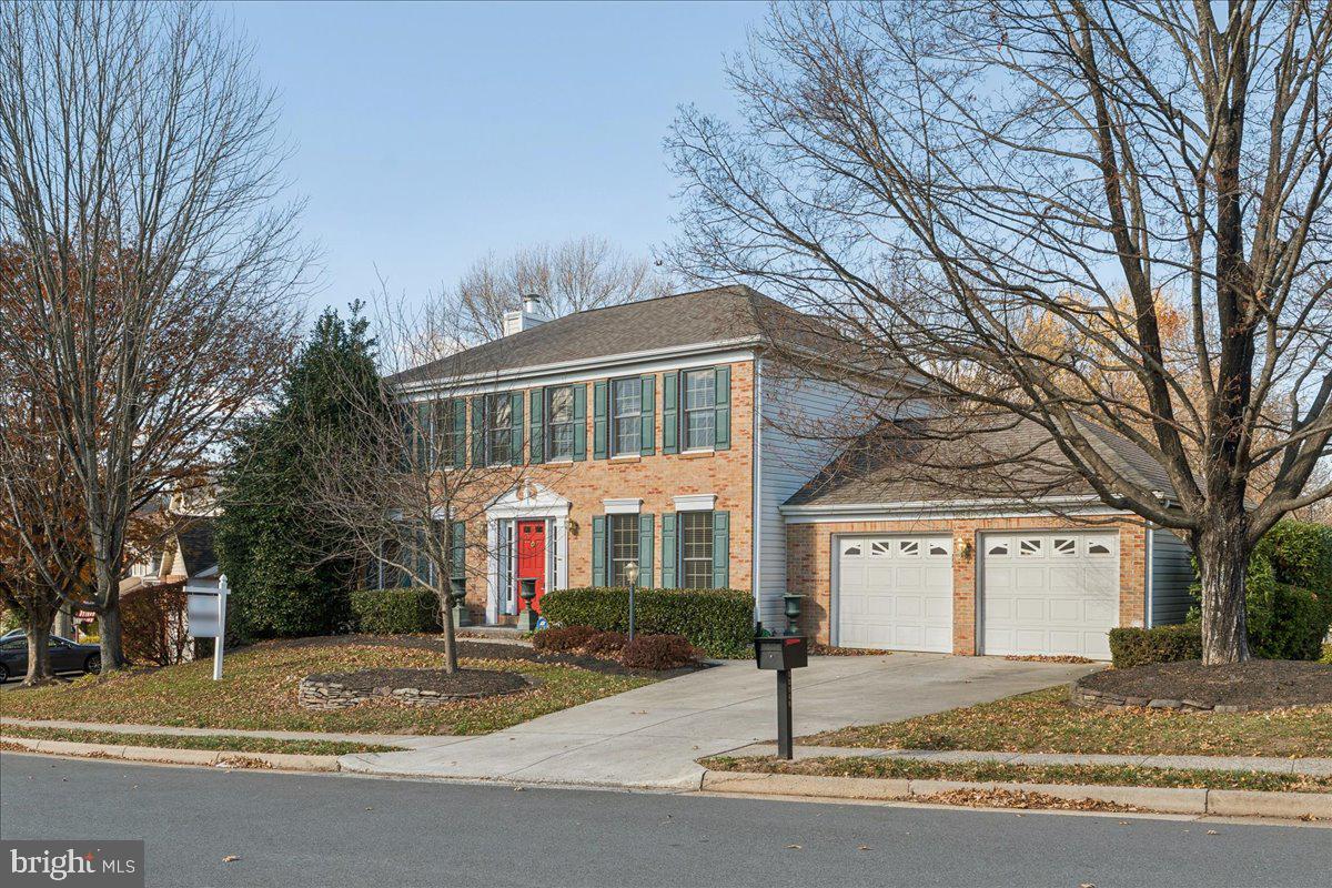 12546 Rock Ridge Road Herndon, VA 20170 - Photo 4 of 44 a front view of a house with a yard and large tree