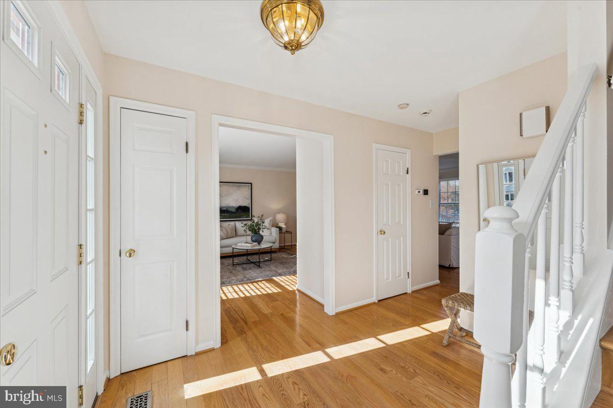 12546 Rock Ridge Road Herndon, VA 20170 - Photo 6 of 44 a bedroom with a bed and a chandelier