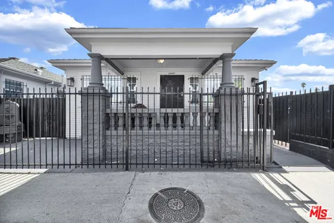an empty room with windows and fireplace