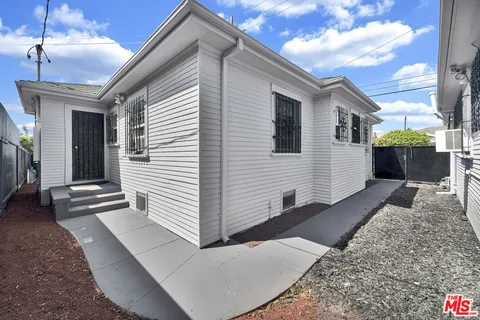 a view of a house next to a yard