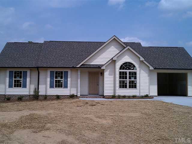 211 Orkney Road, Unit LOT38 Stem, NC 27581 - Photo 1 of 3 a front view of a house with a yard