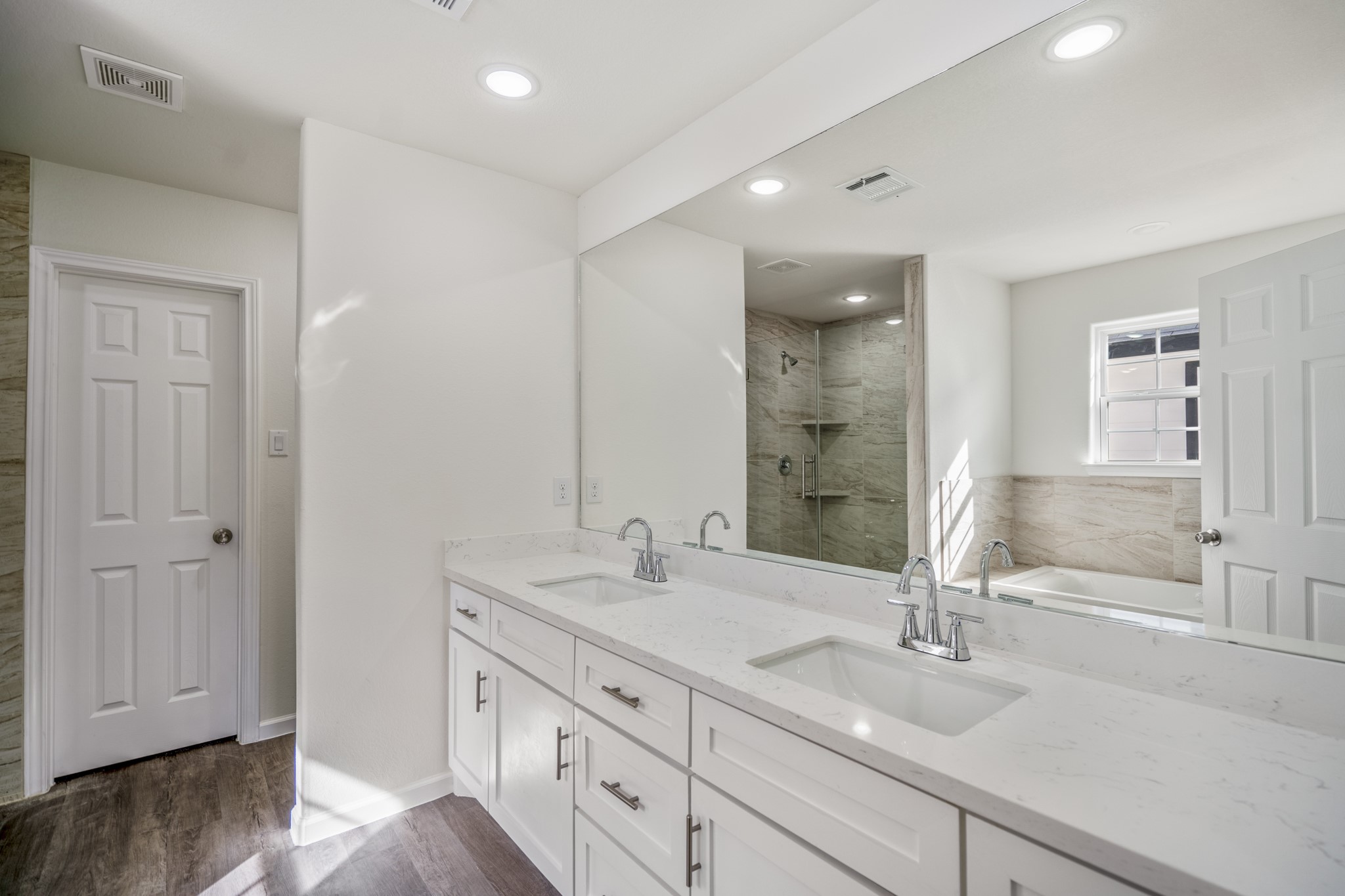 6513 Goldspier Street Houston, TX 77091 - Photo 15 of 31 a bathroom with double vanity sinks and a mirror
