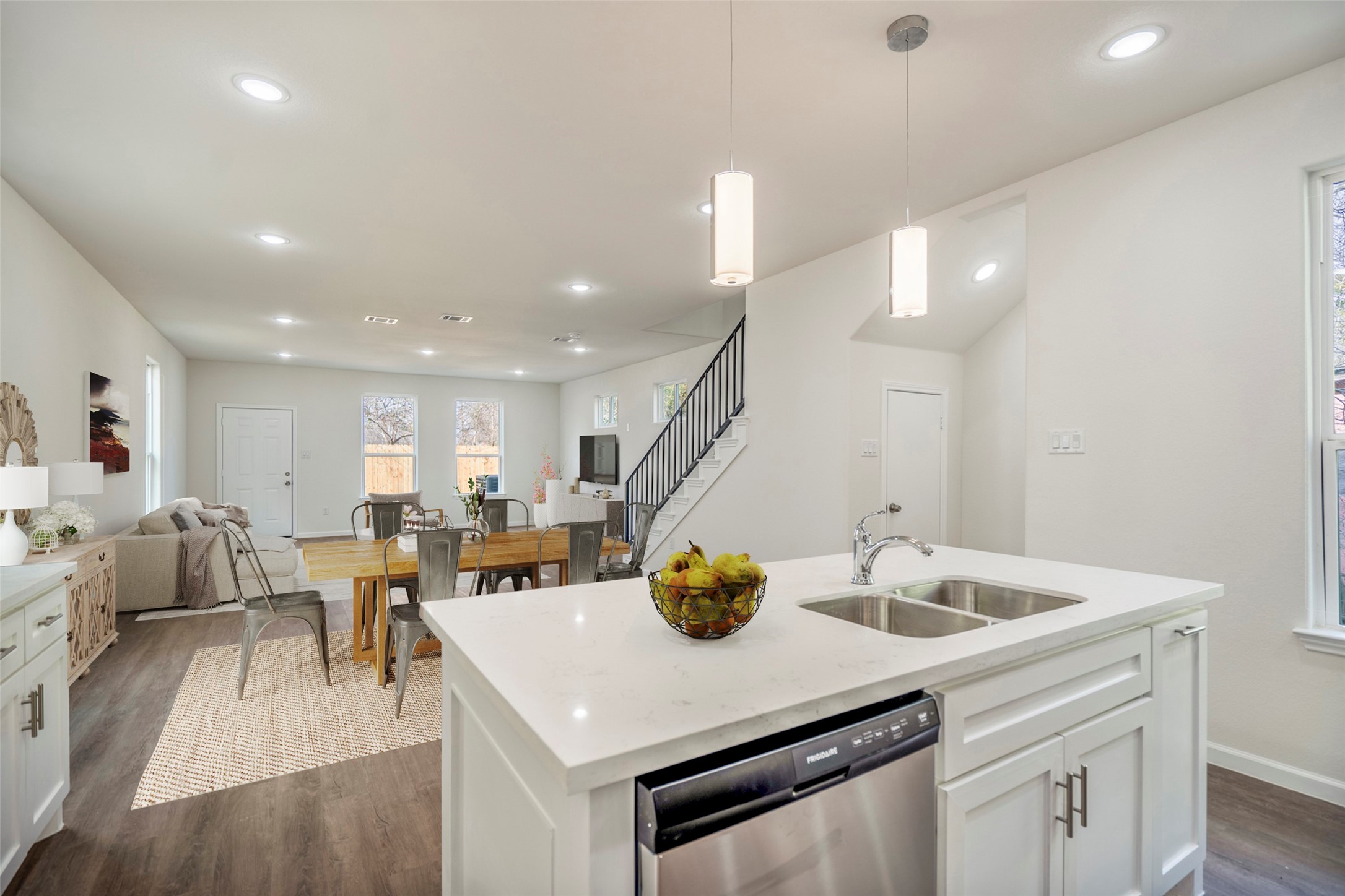 6513 Goldspier Street Houston, TX 77091 - Photo 2 of 31 a kitchen with a sink a stove and chairs