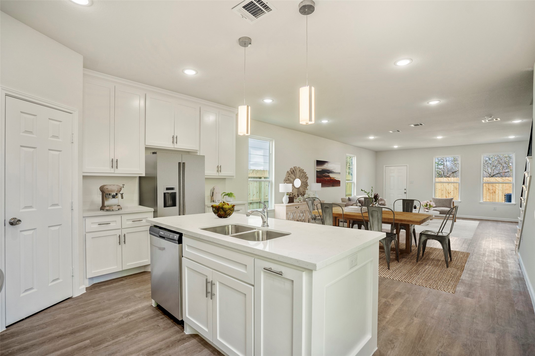 6513 Goldspier Street Houston, TX 77091 - Photo 5 of 31 a kitchen that has a lot of white cabinets and wooden floor