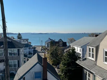 a view of a house with roof deck and seating space