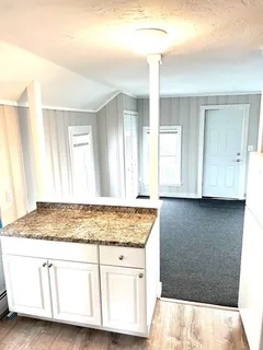 a white toilet and tub sitting next to a bathroom sink
