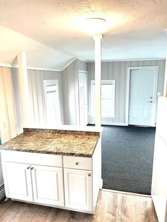 a white toilet and tub sitting next to a bathroom sink