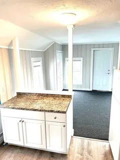 a white toilet and tub sitting next to a bathroom sink
