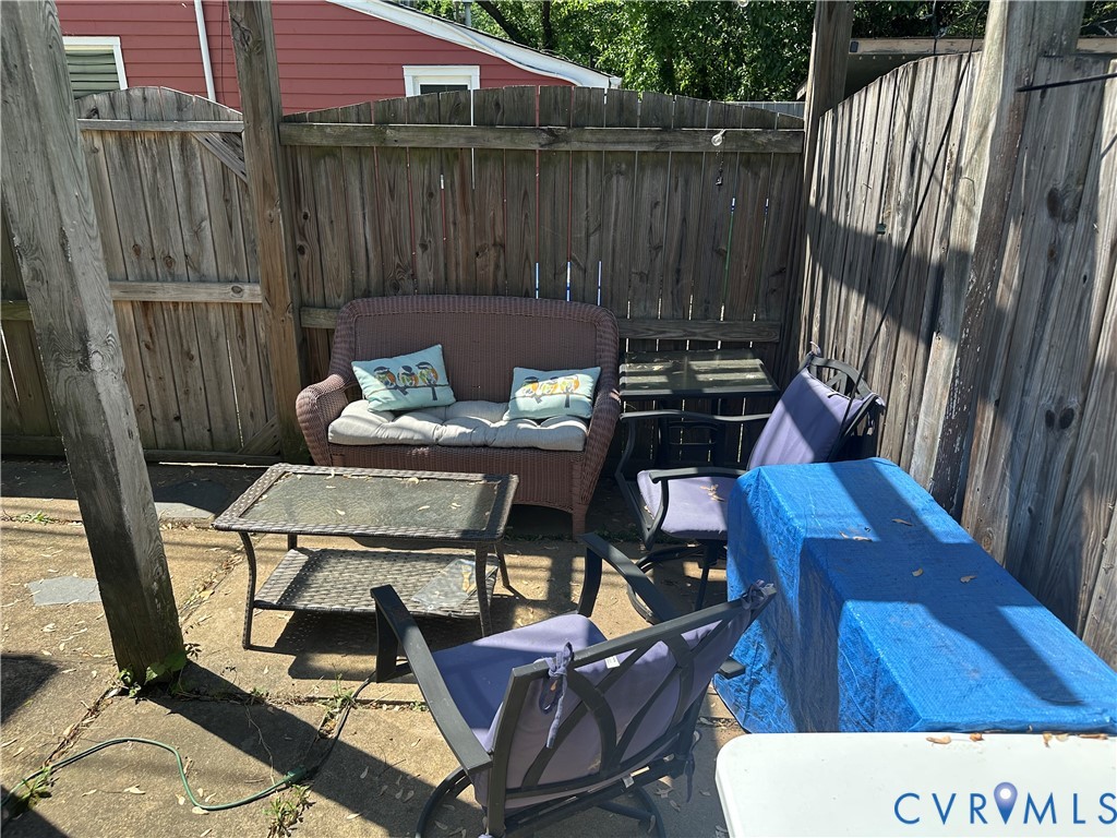 806 Spring Street Richmond, VA 23220 - Photo 14 of 14 a view of a patio with table and chairs with wooden floor and fence