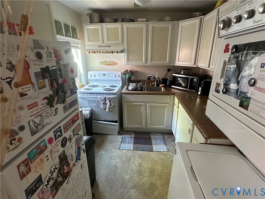 806 Spring Street Richmond, VA 23220 - Photo 6 of 14 a kitchen with stainless steel appliances granite countertop a stove a sink and a refrigerator
