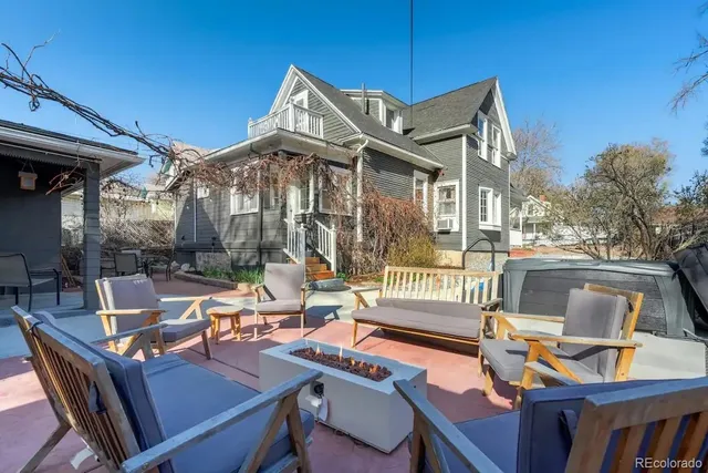 a view of a patio with table and chairs and floor to ceiling window