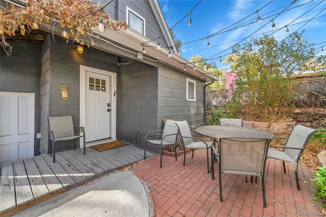 a patio with table and chairs