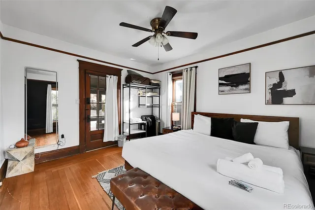 a bedroom with a bed and wooden floor