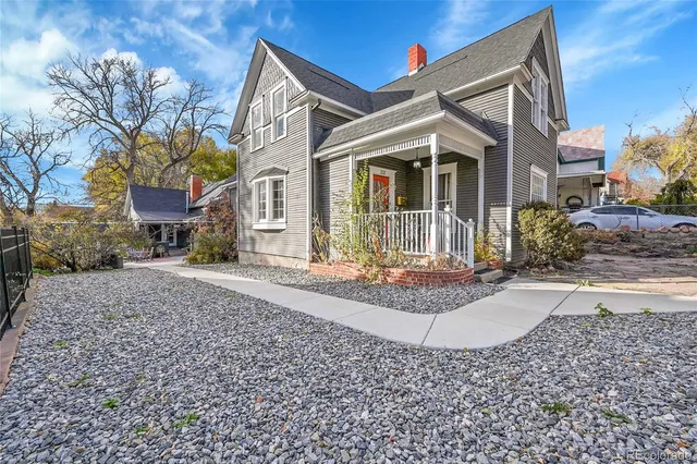 a front view of a house with a yard and outdoor seating