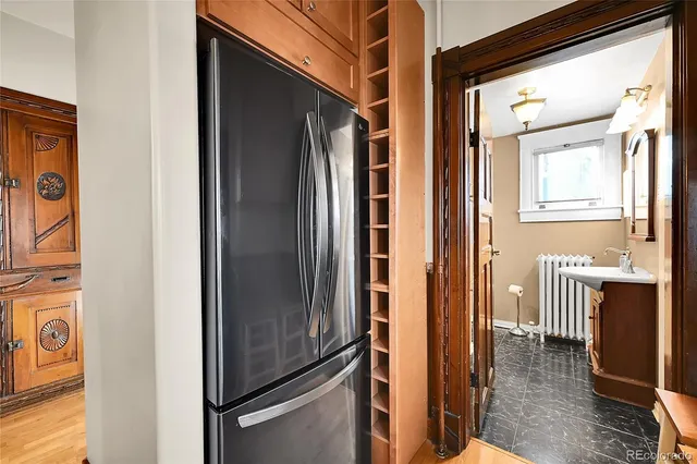 a view of a hallway with wooden floor and glass door