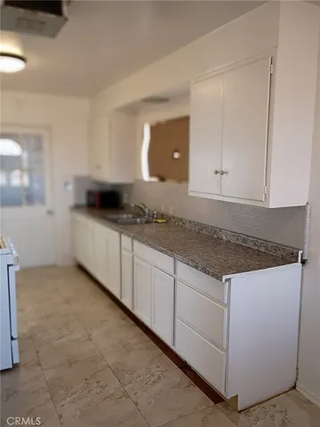 a kitchen with granite countertop white cabinets and a granite counter tops