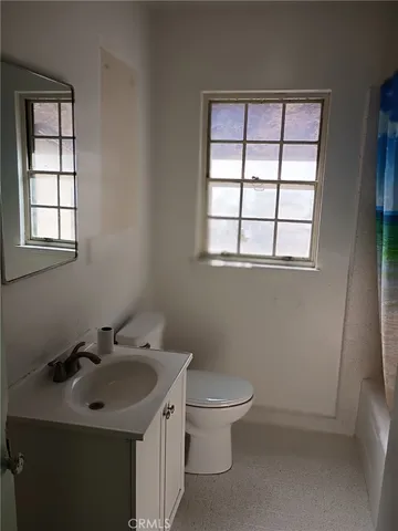a bathroom with a sink toilet and vanity