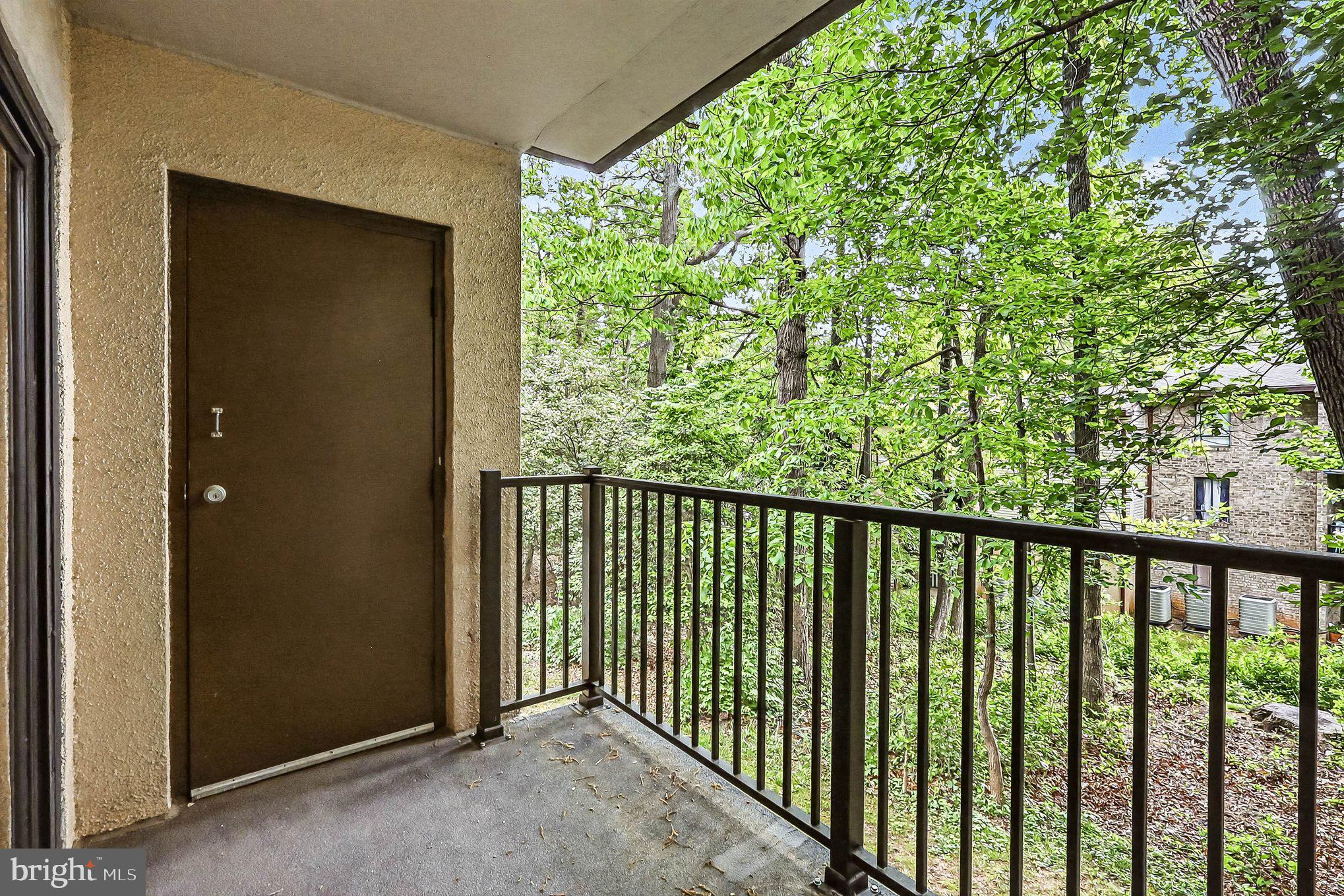 2247 Castle Rock Square, Unit 12C Reston, VA 20191 - Photo 20 of 23 Serene balcony overlooking lush greenery.