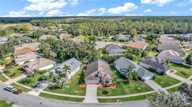 an aerial view of multiple houses with yard